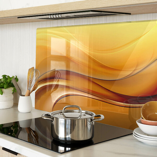 Tagliere in vetro con motivo a onde nei toni dell'oro