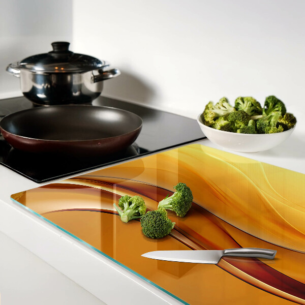 Tagliere in vetro con motivo a onde nei toni dell'oro