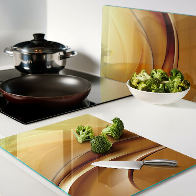 Tagliere in vetro con motivo a onde nei toni dell'oro