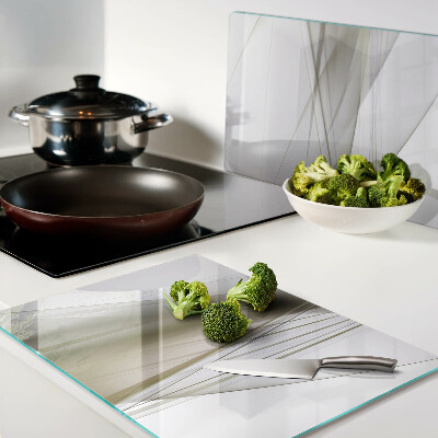 Tagliere in vetro con motivo di linee e forme astratte