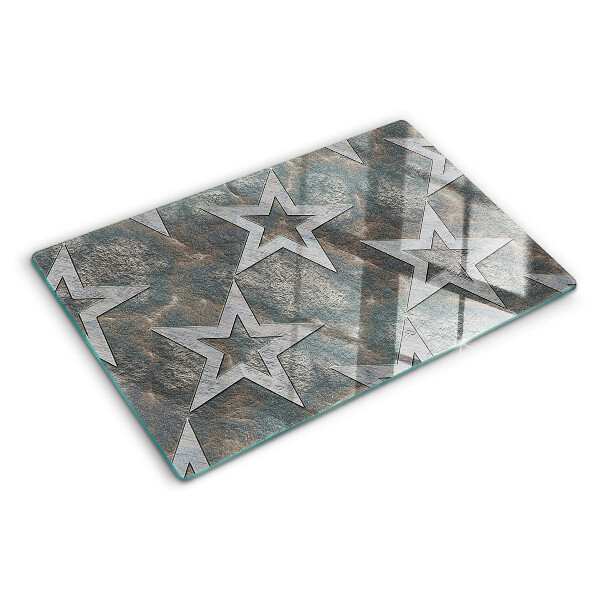 Tagliere in vetro temperato con motivi a stelle su sfondo texturizzato