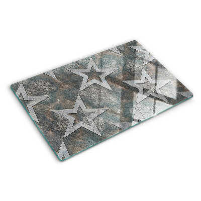 Tagliere in vetro temperato con motivi a stelle su sfondo texturizzato