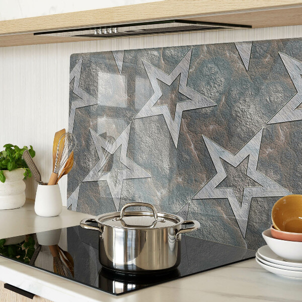 Tagliere in vetro temperato con motivi a stelle su sfondo texturizzato