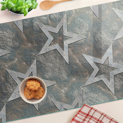 Tagliere in vetro temperato con motivi a stelle su sfondo texturizzato