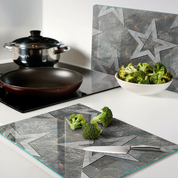 Tagliere in vetro temperato con motivi a stelle su sfondo texturizzato