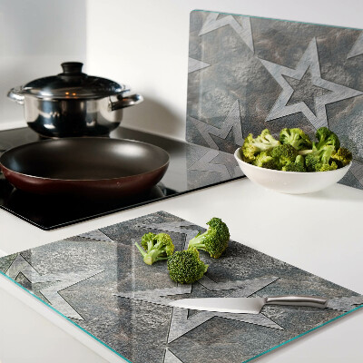 Tagliere in vetro temperato con motivi a stelle su sfondo texturizzato