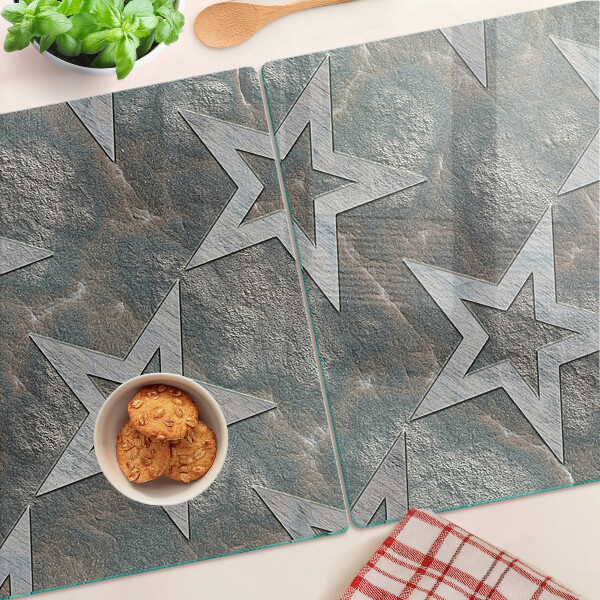 Tagliere in vetro temperato con motivi a stelle su sfondo texturizzato