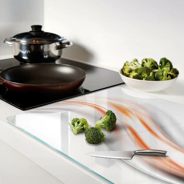 Tagliere in vetro con motivo a onde nei toni dell'arancione e del grigio