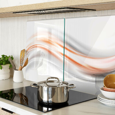 Tagliere in vetro con motivo a onde nei toni dell'arancione e del grigio