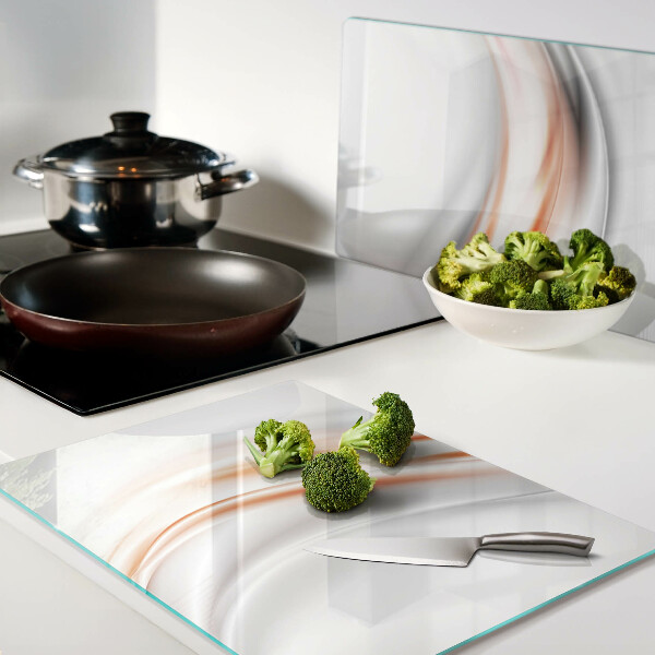 Tagliere in vetro con motivo a onde nei toni dell'arancione e del grigio