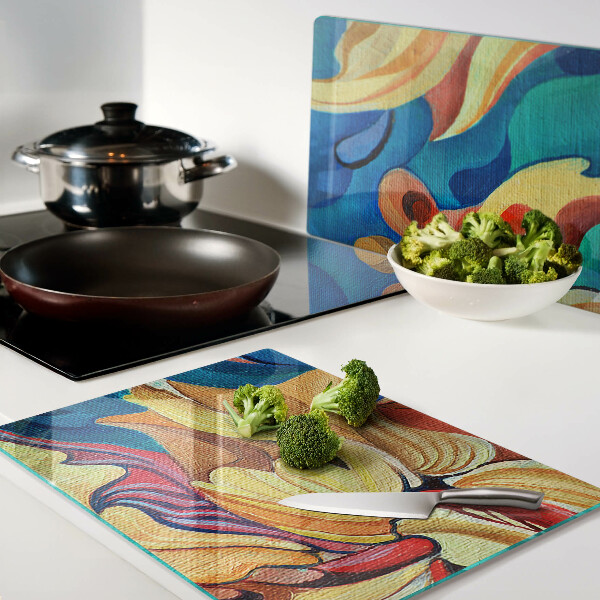 Tagliere in vetro temperato con fiori colorati su uno sfondo astratto