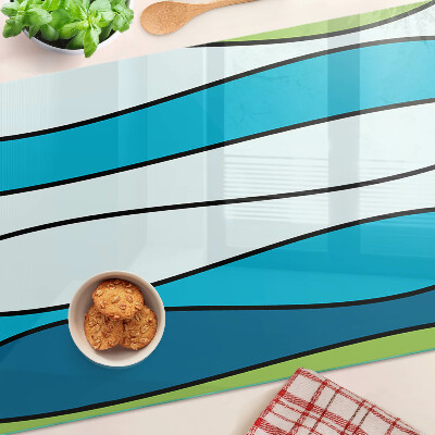 Tagliere in vetro con motivo a onde nei toni del blu e del verde