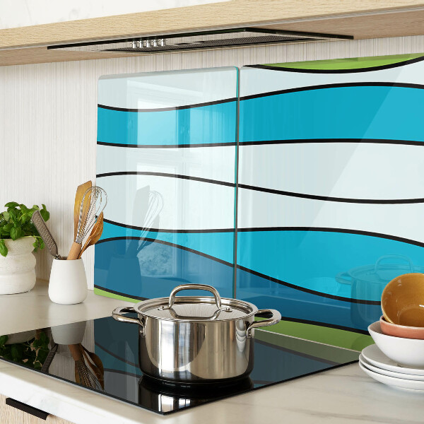 Tagliere in vetro con motivo a onde nei toni del blu e del verde