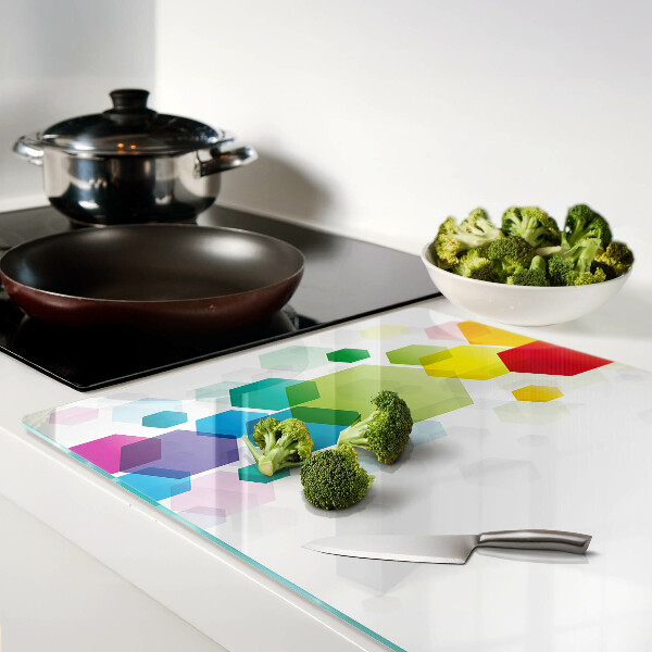 Tagliere in vetro con motivo a esagoni colorati sullo sfondo