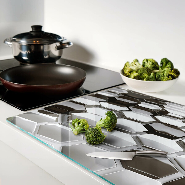 Tagliere in vetro con motivo a strutture esagonali nei toni del grigio