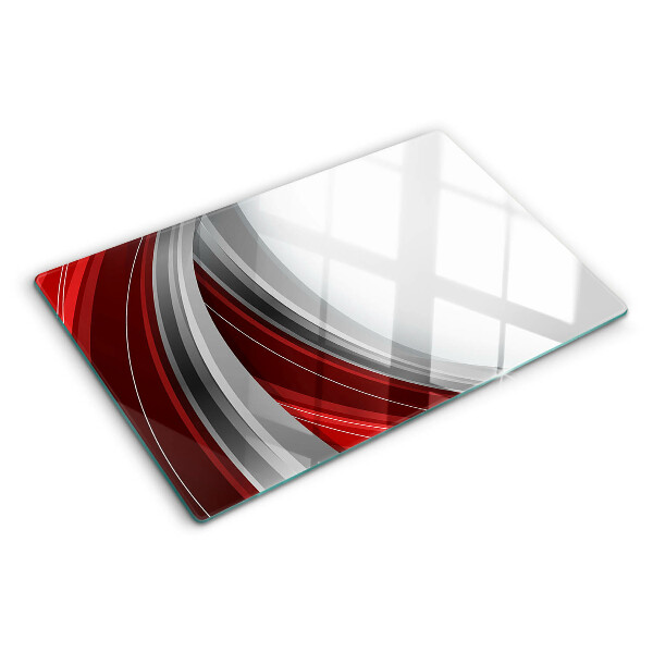 Tagliere in vetro con motivo a onde astratte nei toni del rosso e del grigio