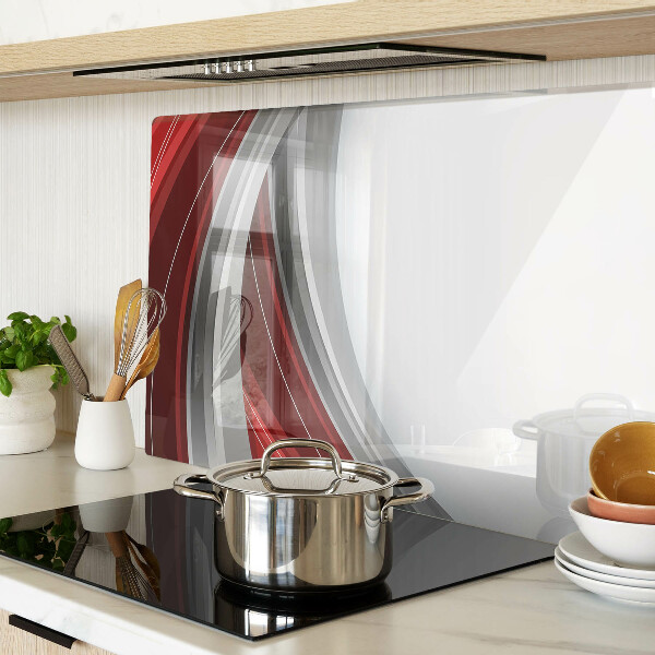 Tagliere in vetro con motivo a onde astratte nei toni del rosso e del grigio