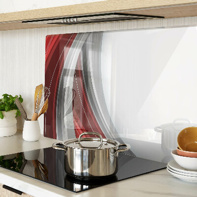 Tagliere in vetro con motivo a onde astratte nei toni del rosso e del grigio