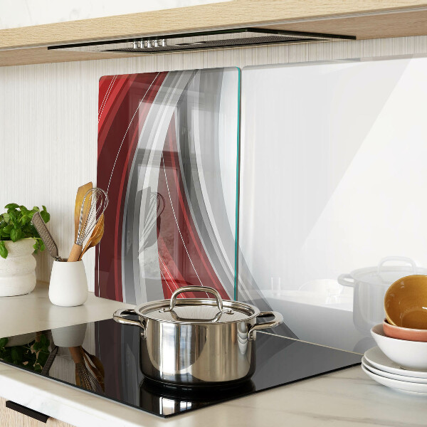 Tagliere in vetro con motivo a onde astratte nei toni del rosso e del grigio