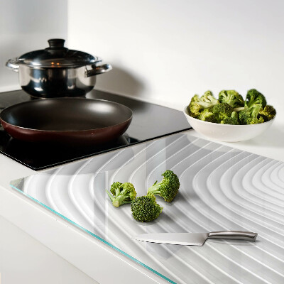 Tagliere in vetro con motivo a onde e linee nei toni del grigio