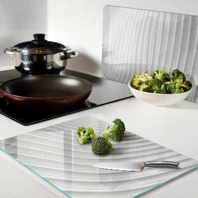 Tagliere in vetro con motivo a onde e linee nei toni del grigio