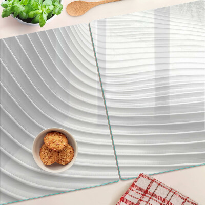 Tagliere in vetro con motivo a onde e linee nei toni del grigio