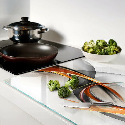 Tagliere in vetro con motivo a onde astratte nei toni dell'oro