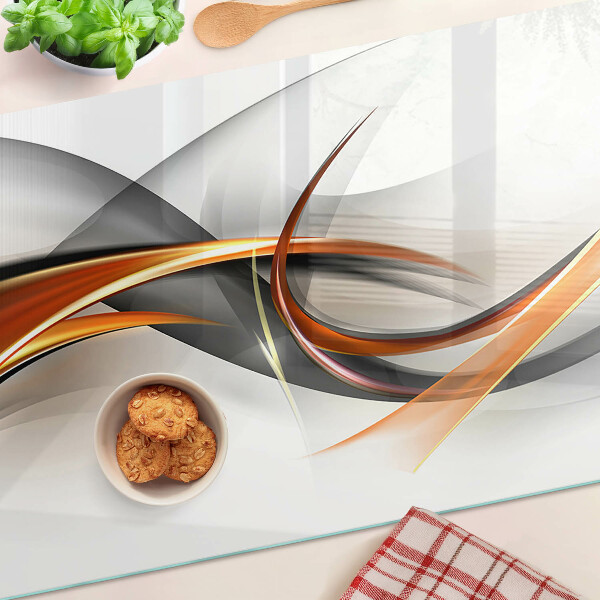 Tagliere in vetro con motivo a onde astratte nei toni dell'oro