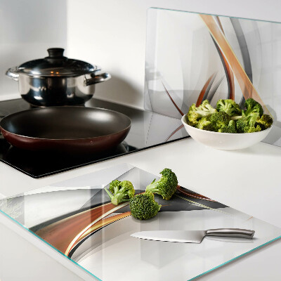 Tagliere in vetro con motivo a onde astratte nei toni dell'oro