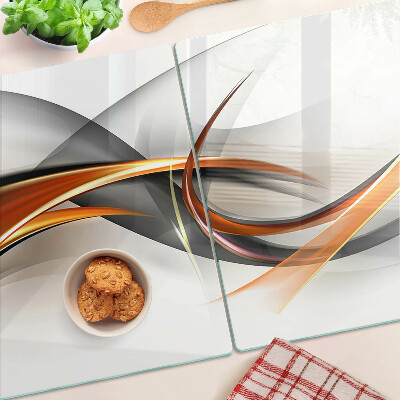 Tagliere in vetro con motivo a onde astratte nei toni dell'oro