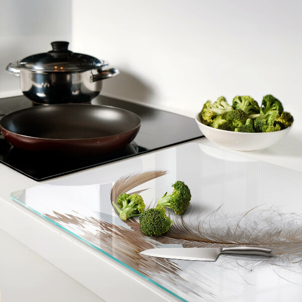 Tagliere in vetro temperato con decoro a piuma su sfondo acqua