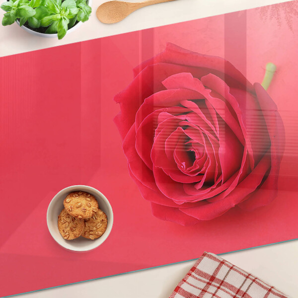 Tagliere in vetro con motivo di rosa rossa sullo sfondo