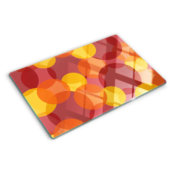 Tagliere in vetro temperato con motivo di cerchi in toni caldi