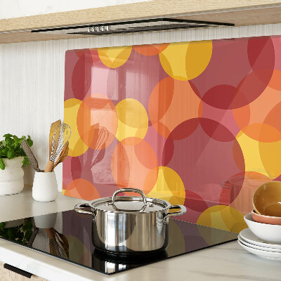 Tagliere in vetro temperato con motivo di cerchi in toni caldi