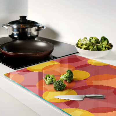 Tagliere in vetro temperato con motivo di cerchi in toni caldi