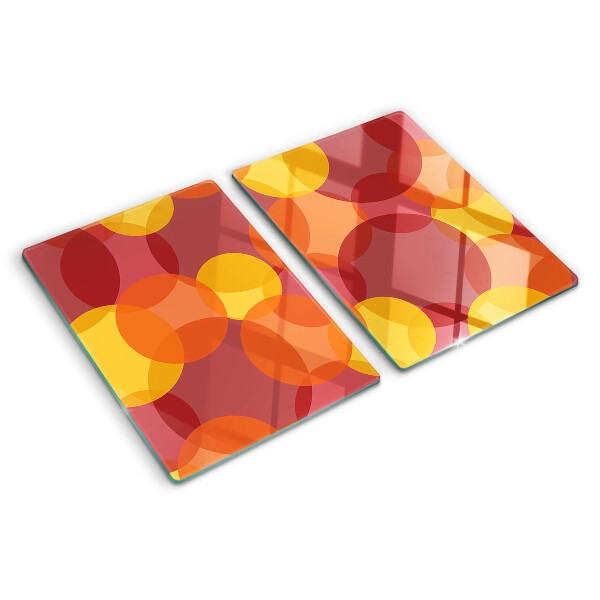 Tagliere in vetro temperato con motivo di cerchi in toni caldi
