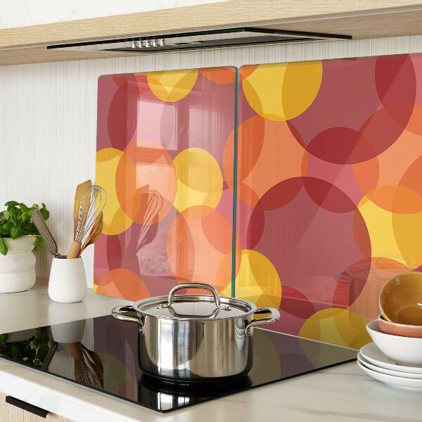Tagliere in vetro temperato con motivo di cerchi in toni caldi