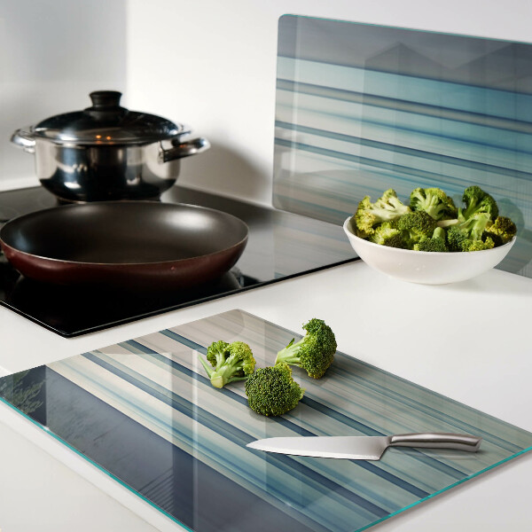 Tagliere in vetro con motivo a linee astratte nei toni del blu