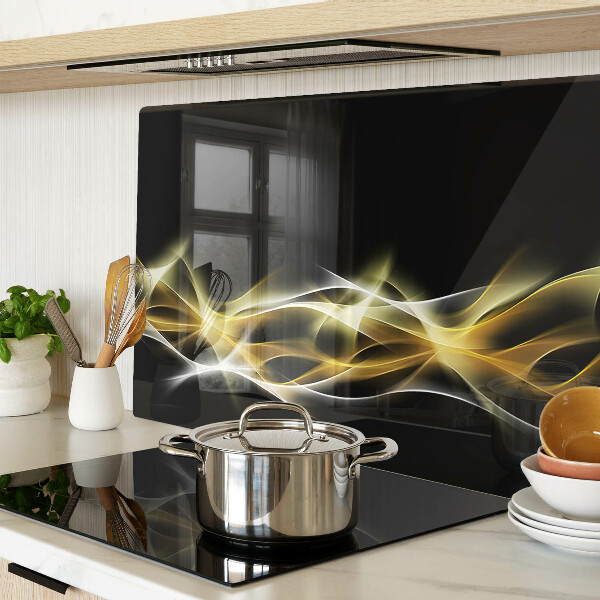 Tagliere in vetro con motivo a onda di luce nei toni dell'oro