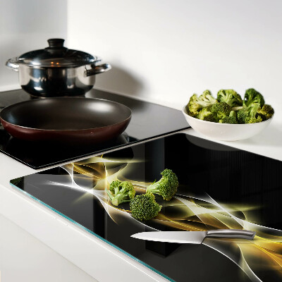 Tagliere in vetro con motivo a onda di luce nei toni dell'oro