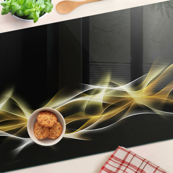 Tagliere in vetro con motivo a onda di luce nei toni dell'oro