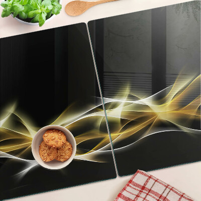 Tagliere in vetro con motivo a onda di luce nei toni dell'oro