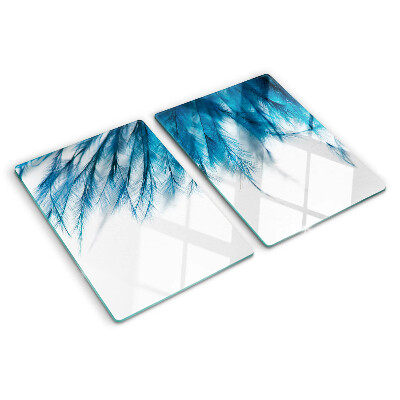 Tagliere in vetro con motivo di piume blu su sfondo bianco