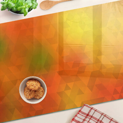 Tagliere in vetro con motivo geometrico nei toni dell'arancione