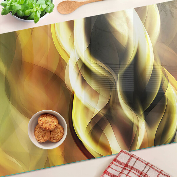 Tagliere in vetro con decorazione a onde astratte nei toni dell'oro