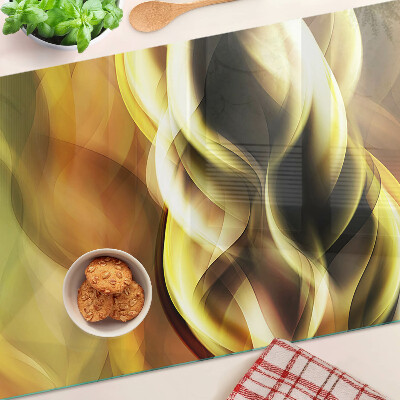 Tagliere in vetro con decorazione a onde astratte nei toni dell'oro