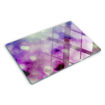 Tagliere in vetro con motivo bokeh nei toni del viola e del rosa