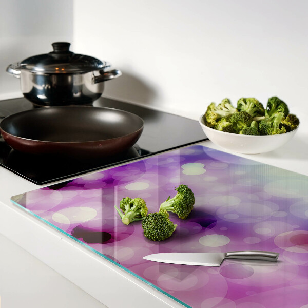 Tagliere in vetro con motivo bokeh nei toni del viola e del rosa