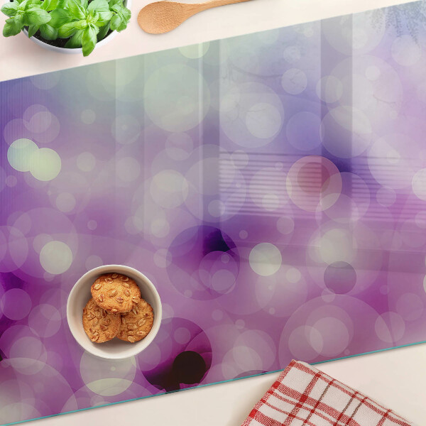 Tagliere in vetro con motivo bokeh nei toni del viola e del rosa