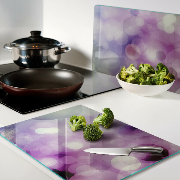 Tagliere in vetro con motivo bokeh nei toni del viola e del rosa